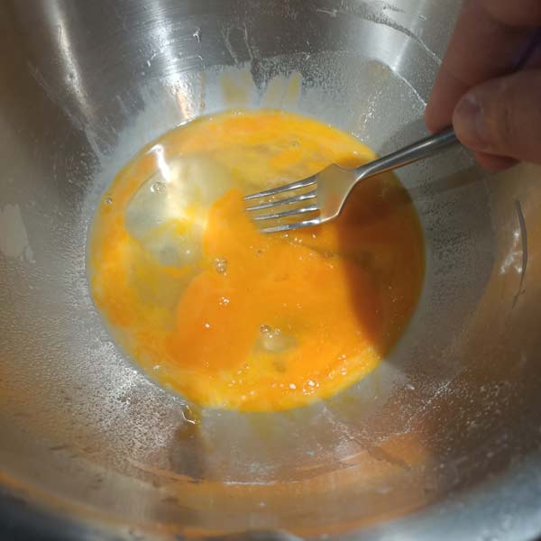Whisking egg for pasta dough