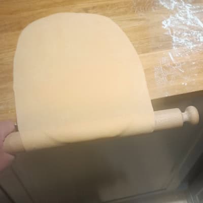 Unfurling pasta off the edge of the bench