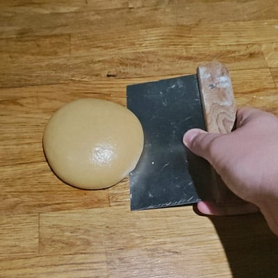 Using dough scraper on fresh pasta